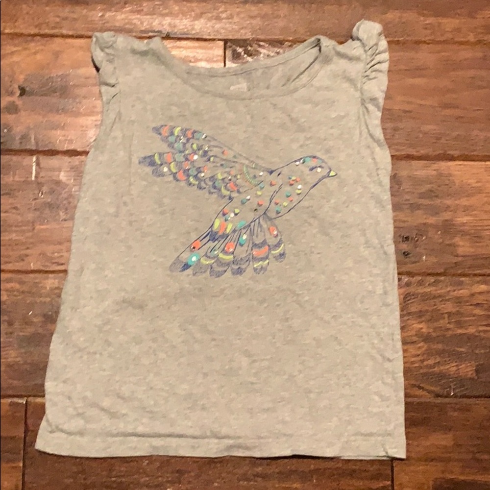 It is a cute short sleeved top with a  bird design
